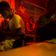 A woman sits alone in a karaoke bar in Manakara